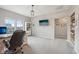 Bright office features a view of the neighborhood, custom bookshelves, and a doorway to another room at 1442 Avondale Dr, Westfield, IN 46074