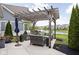Backyard patio offers a pergola, grill, comfortable seating, and scenic water view at 15250 Mooring E Cir, Carmel, IN 46033