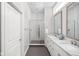 Modern bathroom with double vanity, walk-in shower, and tiled floors and walls at 15250 Mooring E Cir, Carmel, IN 46033