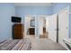 Bedroom boasts blue walls with connected bath and hallway entrances and a wood dresser at 15250 Mooring E Cir, Carmel, IN 46033