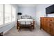 Bedroom features wooden bed frame, dresser, bench, light blue walls, and plantation shutters at 15250 Mooring E Cir, Carmel, IN 46033