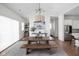 Dining room with large table, gray rug and view into other rooms of the house at 15250 Mooring E Cir, Carmel, IN 46033