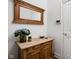 Entryway with rustic wood accent table, decorative mirror, and stylish decor at 15250 Mooring E Cir, Carmel, IN 46033