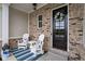Cozy front porch with seating, a decorative wreath, and a welcoming entrance into the home at 15250 Mooring E Cir, Carmel, IN 46033