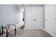 Hallway features neutral carpet and paint with large closet doors and a decorative chair at 15250 Mooring E Cir, Carmel, IN 46033