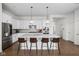 Bright, white kitchen with large center island, modern stainless appliances, and stylish pendant lighting at 15250 Mooring E Cir, Carmel, IN 46033