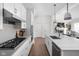 Open-concept kitchen with white cabinets, stone countertops, stainless appliances and seamless transition to living room at 15250 Mooring E Cir, Carmel, IN 46033