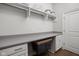 A clean laundry room with a gray countertop, cabinets, and storage for laundry essentials at 15250 Mooring E Cir, Carmel, IN 46033