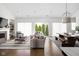 Spacious living room with abundant natural light, open to the dining area, creating a seamless living space at 15250 Mooring E Cir, Carmel, IN 46033