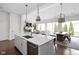 Bright open-concept kitchen and dining room with an island and stainless steel appliances at 15250 Mooring E Cir, Carmel, IN 46033