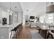 Open-concept living space featuring a kitchen island, dining area, and living room with fireplace at 15250 Mooring E Cir, Carmel, IN 46033