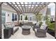Outdoor patio featuring a pergola, fire table, grill, and comfortable seating area at 15250 Mooring E Cir, Carmel, IN 46033