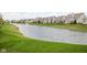 Scenic view of the pond and well-manicured lawn within the community at 15250 Mooring E Cir, Carmel, IN 46033