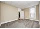 Bedroom featuring tan colored walls, soft carpet, and an ensuite bathroom at 156 S Cross St, Clayton, IN 46118