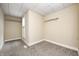 Bedroom featuring tan colored walls, soft carpet, natural light, and closet organizers at 156 S Cross St, Clayton, IN 46118
