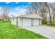 A detached two-car garage with a gravel driveway and well-maintained lawn at 156 S Cross St, Clayton, IN 46118