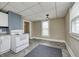 Galley kitchen featuring an oven range, grey tile floors, and natural light at 156 S Cross St, Clayton, IN 46118