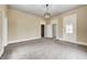 Neutral living room featuring new carpet, white trim, and easy access to other rooms at 156 S Cross St, Clayton, IN 46118