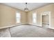 Spacious carpeted living room with large windows and a decorative ceiling light at 156 S Cross St, Clayton, IN 46118