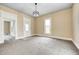 Neutral living room with carpet, modern light fixture, and bright natural light at 156 S Cross St, Clayton, IN 46118