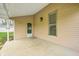 Covered porch with concrete floor and an exterior light fixture at 156 S Cross St, Clayton, IN 46118