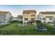 A sprawling backyard with a well-maintained lawn, a patio, and a black metal fence at 15958 Oakhurst Ln, Fishers, IN 46040