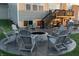 Outdoor patio features firepit with gray Adirondack chairs and stamped concrete, creating an inviting backyard space at 15958 Oakhurst Ln, Fishers, IN 46040