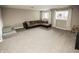 Finished basement featuring plush carpeting, a brown sectional sofa, and abundant natural light at 15958 Oakhurst Ln, Fishers, IN 46040