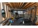 Unfinished basement offers a home gym with black rubber floors and exposed wood ceiling at 15958 Oakhurst Ln, Fishers, IN 46040