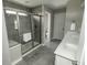 Modern bathroom featuring a glass-enclosed shower and double vanity sinks at 15958 Oakhurst Ln, Fishers, IN 46040