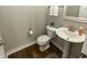 Neutral powder room with hardwood floors, pedestal sink, and decorative details at 15958 Oakhurst Ln, Fishers, IN 46040