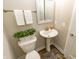 Charming bathroom with pedestal sink, a decorative mirror, and neutral wall color at 15958 Oakhurst Ln, Fishers, IN 46040