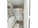 Well-lit bathroom featuring a double vanity, tiled floors, and a shower/tub combination at 15958 Oakhurst Ln, Fishers, IN 46040