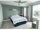 Well-lit bedroom featuring neutral walls, ceiling fan, and large windows for a bright, airy feel at 15958 Oakhurst Ln, Fishers, IN 46040