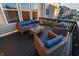 Outdoor deck featuring wicker furniture with blue cushions, creating an inviting space for relaxation and entertainment at 15958 Oakhurst Ln, Fishers, IN 46040