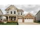 Charming two-story home with a brick and siding exterior and a two car garage at 15958 Oakhurst Ln, Fishers, IN 46040