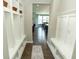 Inviting hallway with built-in storage, hardwood floors, and sight lines to the dining and living areas at 15958 Oakhurst Ln, Fishers, IN 46040