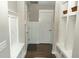 Entryway with built-in seating, storage, and hardwood floors leading to the front door at 15958 Oakhurst Ln, Fishers, IN 46040