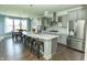 Open-concept kitchen with quartz island, modern appliances, and adjacent dining area at 15958 Oakhurst Ln, Fishers, IN 46040