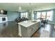 Open layout with modern kitchen island flowing into the living and dining areas at 15958 Oakhurst Ln, Fishers, IN 46040