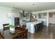 Bright kitchen featuring a large island, pendant lighting, stainless steel appliances, and dining area at 15958 Oakhurst Ln, Fishers, IN 46040