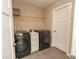 Bright laundry room features front-load washer and dryer, storage cabinets, and a convenient wire shelf at 15958 Oakhurst Ln, Fishers, IN 46040