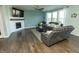 Spacious living room featuring a fireplace, large windows, and hardwood floors at 15958 Oakhurst Ln, Fishers, IN 46040