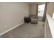Inviting living room area with neutral tones, a large window, and a comfortable seating arrangement at 15958 Oakhurst Ln, Fishers, IN 46040