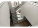 Stairway with carpeted steps and a black banister adorned with decorative accents on the landings at 15958 Oakhurst Ln, Fishers, IN 46040