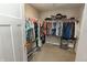 Spacious walk-in closet with ample hanging space, shelving, and storage containers at 15958 Oakhurst Ln, Fishers, IN 46040