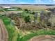 Panoramic aerial view showcasing a creek winding through the property and surrounding greenery at 2025 State Road 47, Lebanon, IN 46052