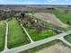 Aerial view showing the property entrance, creek, and surrounding fields at 2025 State Road 47, Lebanon, IN 46052