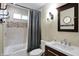 This bathroom has tile walls, a shower/tub combo with a curtain, a toilet, a sink, and a mirror at 2025 State Road 47, Lebanon, IN 46052