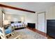 Comfortable bedroom with wood floors, a patterned rug, a dresser, and a bed with a plaid comforter at 2025 State Road 47, Lebanon, IN 46052